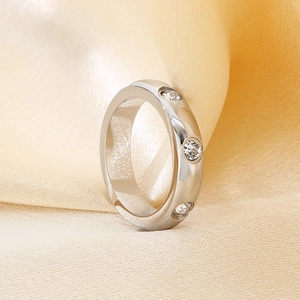 Polished silver stainless steel ring with three clear crystals on champagne silk