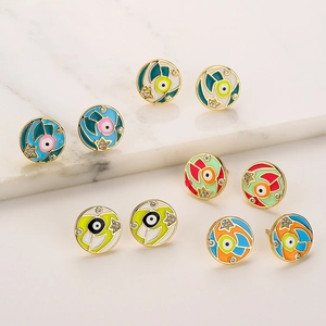 Set of gold-plated enamel eye stud earrings with colorful zircon stones on marble