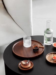Close-up of circular dark walnut wood tray showing natural grain for coffee and desserts