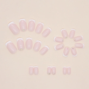 Classic pink and white French manicure press-on nails with sparkling rhinestones decoration