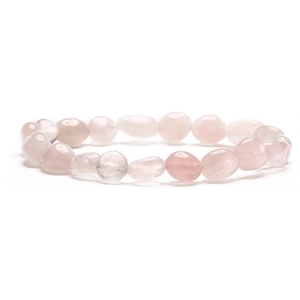 Macro detail of natural irregular rose quartz stone beads on a polished handmade bracelet