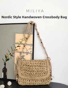 Detail of woven straw crossbody bag with decorative beaded strap and fan-shaped flap