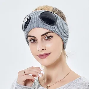 Grey ribbed knit headband featuring integrated black goggles shown on a female model