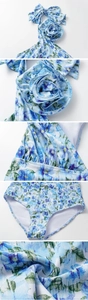 Detailed close-up of 3D floral decoration and bow on blue floral one-piece swimsuit