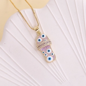 Detail of gold flip-flop necklace with purple evil eye enamel on white shell