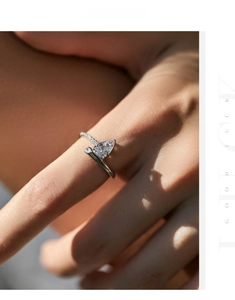 Macro detail of pear-cut sparkling diamond ring with irregular 925 silver band on finger