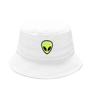 Close-up of neon yellow alien head embroidery on a white cotton bucket hat