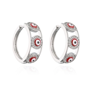 Detailed view of silver hoop earrings featuring red and black zircon Evil Eye patterns