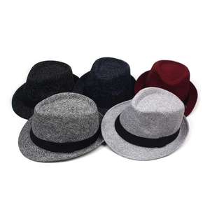 Flat lay of fedora hats in five colors including black and burgundy with ribbons