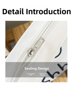 Detailed macro view of high-quality metal zipper closure on white canvas shoulder bag