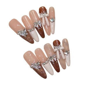 Handmade almond press-on nails in beige and brown with 3D bows and pearls