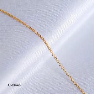 Detailed view of an 18K gold-plated cable chain on elegant white satin fabric