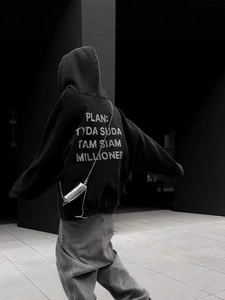 Oversized black hoodie with rhinestone lettering and wide-leg pants streetwear style