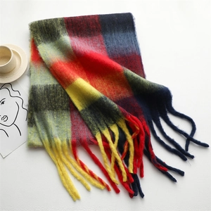 Close-up of vibrant multi-color plaid scarf with soft fringe and thick cashmere texture