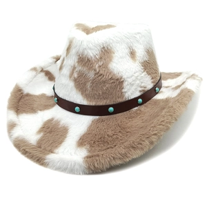 Detail of cow print cowboy hat with plush texture and turquoise studded leather band