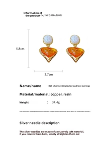 Detail view of vintage heart drop earrings with orange resin and dimension specs