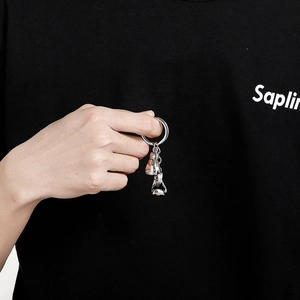 Polished silver stainless steel boxing glove keychain shown held in hand