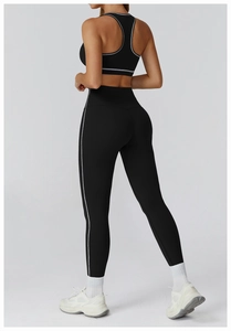 Close-up of black sports set with white contrast lines and high-waisted yoga leggings