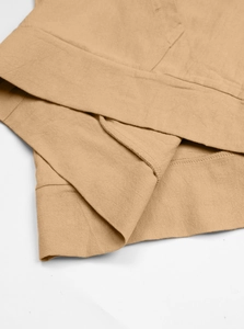 Detail of khakilinen-cotton shirt hem with professional stitching and knit texture