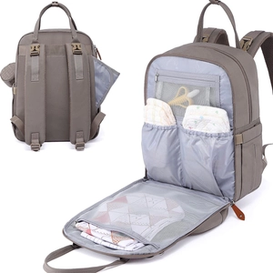 Detail of grey diaper bag showing ergonomic back straps and organized inner compartments