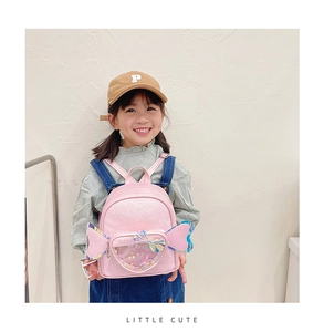Toddler girl backpack featuring pink glitter material and heart-shaped window on the back