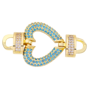 Detailed close-up of a heart-shaped jewelry clasp set with blue turquoise and white zircons