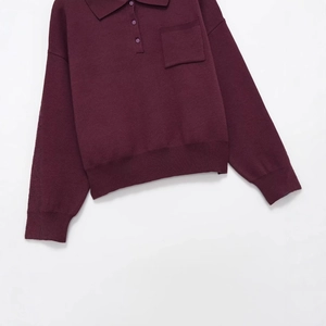 Deep wine red knit polo shirt with long sleeves, chest pocket, and ribbed cuffs
