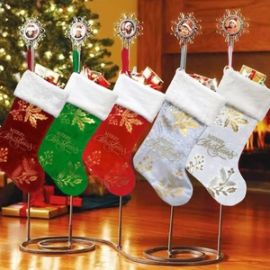 Velvet Christmas stockings with Merry Christmas embroidery hanging on metal rack