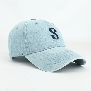 Detail of the letter S embroidery and fabric texture on a washed denim baseball cap