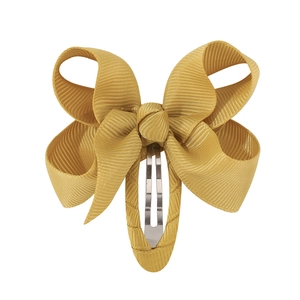 Close-up of yellow grosgrain fabric bow hair clip with silver metal BB snap fastener