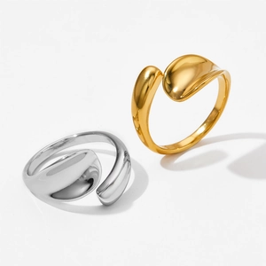 Irregular stainless steel open rings in gold and silver finish on a clean background