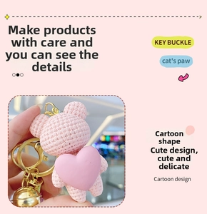 Detailed view of pink resin bear keychain featuring a woven texture and golden metal bell