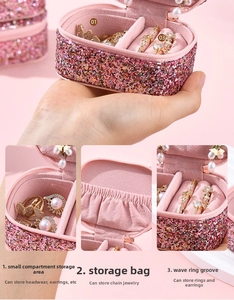 Pink glitter jewelry box with ring slots, earring compartments and interior pocket