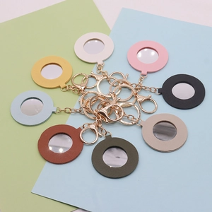 Flat lay of colorful heart-shaped PU leather mirrors with gold lobster clasps and chains