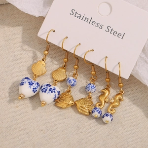 Three pairs of vintage 18K gold plated stainless steel earrings with blue ceramic beads