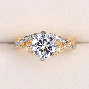 Detailed close-up of a two-tone twisted band engagement ring with a four-prong zircon setting