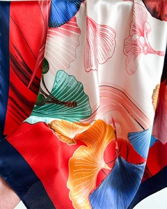 Detailed macro view of colorful ginkgo leaf patterns on smooth satin silk square scarf