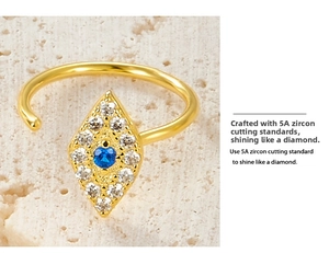 Macro shot of 925 silver evil eye ring with blue zircon and gold plating details