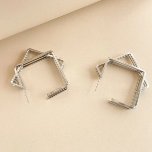 Detail of silver double-layered geometric square earrings with a polished metallic finish