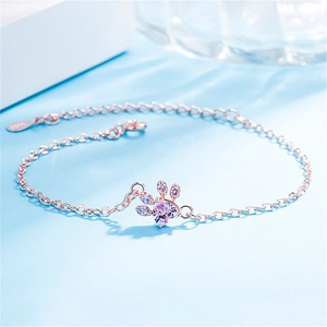 Close-up of S925 rose gold cat paw bracelet with pink heart stone and zircons