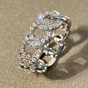 Macro shot of silver curb link ring featuring micro-paved sparkling cubic zirconia