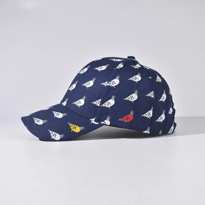 Navy blue baseball cap featuring all-over pigeon print and a classic curved brim