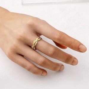 Detail of gold-plated corrugated segment ring showing textured oval metal beads
