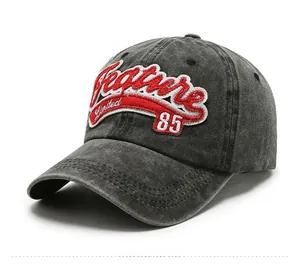 Detailed side view of charcoal grey washed cotton baseball cap with vintage embroidery