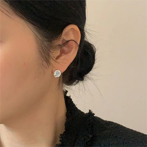 Close-up of S925 silver lava-style stud earring with iridescent shell inlay on a model