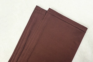 Detail of double-needle stitching and hem on the coffee brown ruched bodycon dress fabric