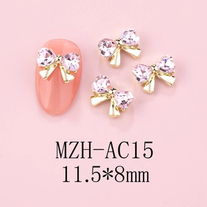 Pink heart crystal bow nail charms with gold alloy base and size detail macro view