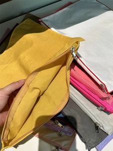 Detailed macro view of yellow nylon bag showing smooth metal zipper and internal space