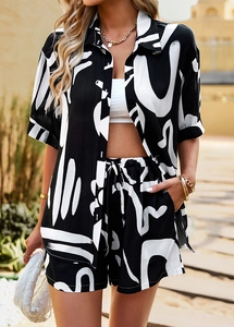 Close-up of black and white abstract print on short-sleeve shirt and drawstring shorts set