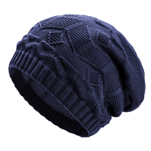 Detail of dark blue knit beanie featuring warm grey fleece lining and diamond patterns